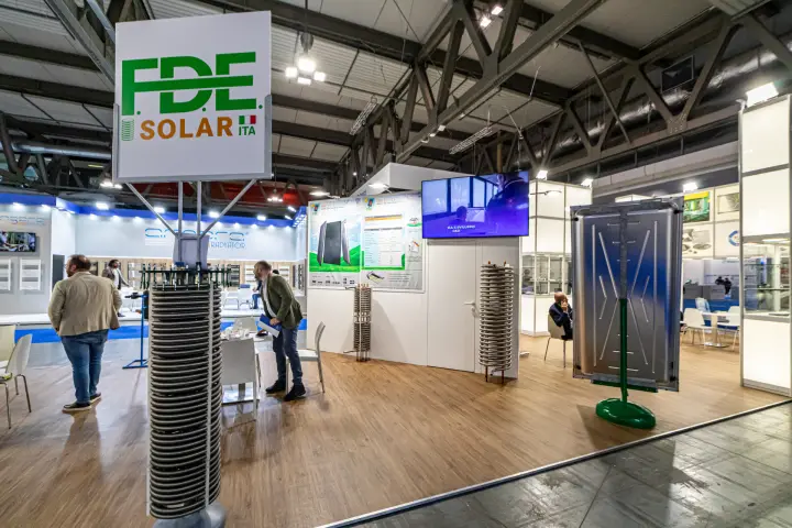 F.D.E. Solar ITA sign above a coil tower and a steel solar absorber panel at MCE 2024