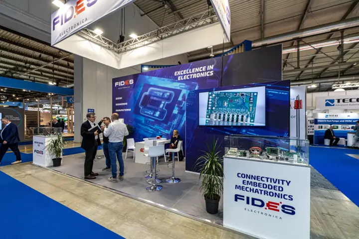 Fides Electrónica hanging banner and circuit board on screen