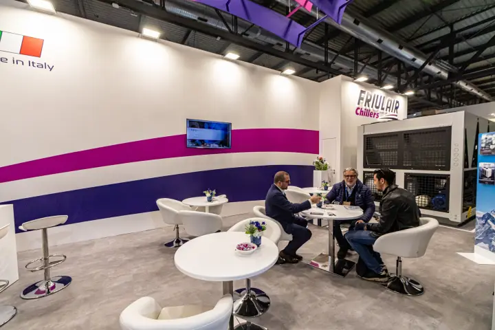 Friulair meeting area with white tub chairs and a chiller behind at MCE 2024