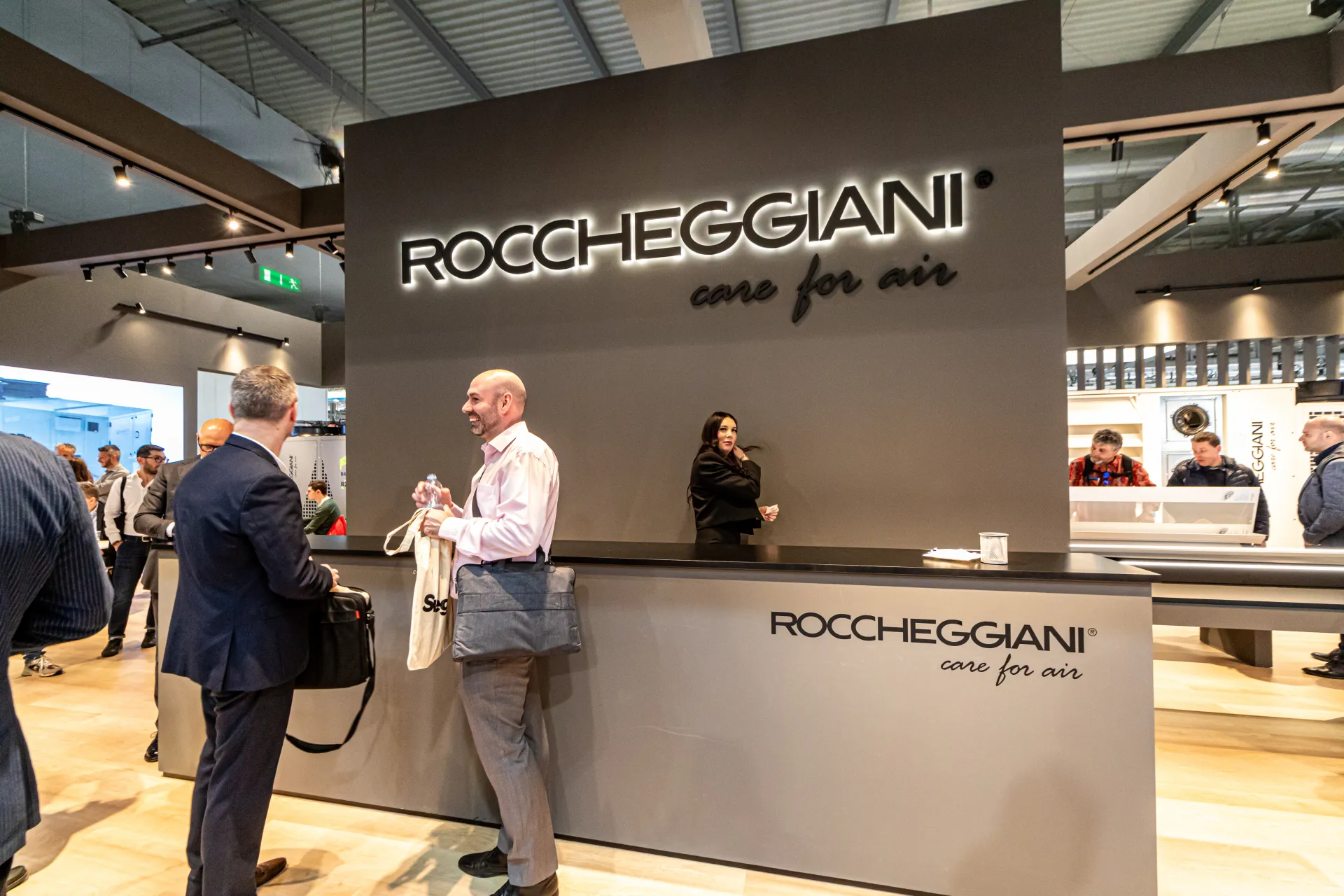 Front view of the Roccheggiani welcome desk and illuminated logo wall at MCE 2024