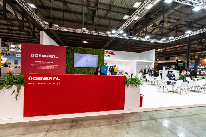 Fujitsu General reception counter with green wall and red branding at MCE 2024