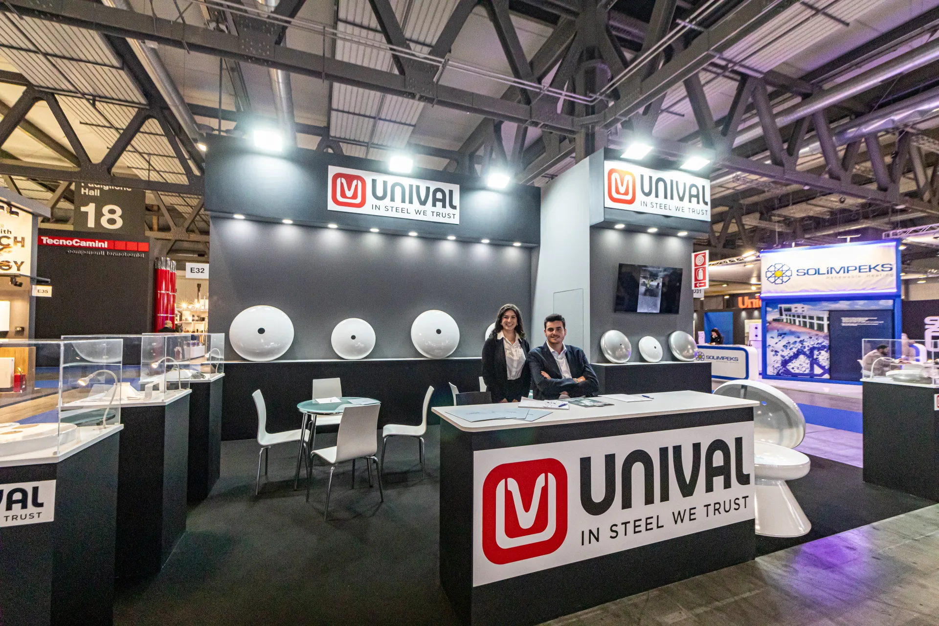 Full view of the Unival stand in hall 18 with branded reception desk at MCE 2024