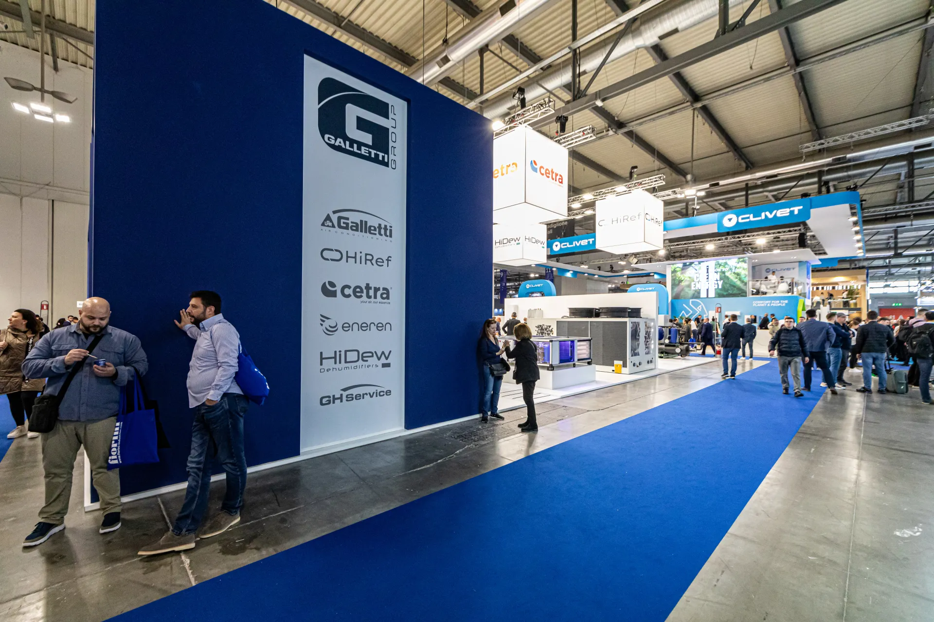 Galletti Group wall listing its brands beside a blue-carpeted aisle at MCE 2024