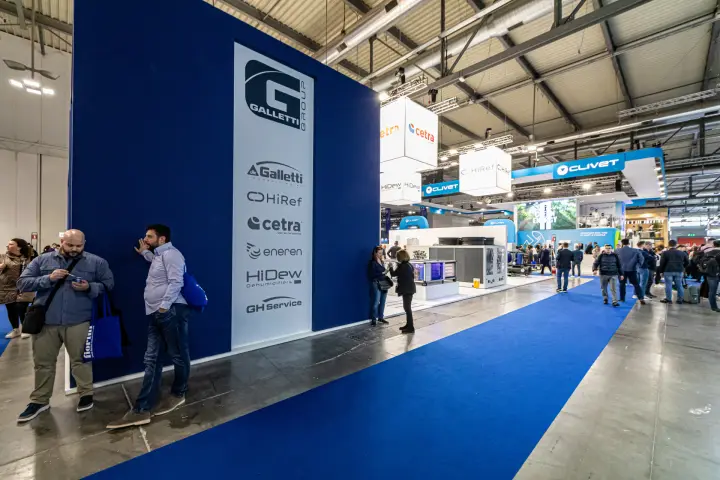 Galletti Group wall listing its brands beside a blue-carpeted aisle at MCE 2024