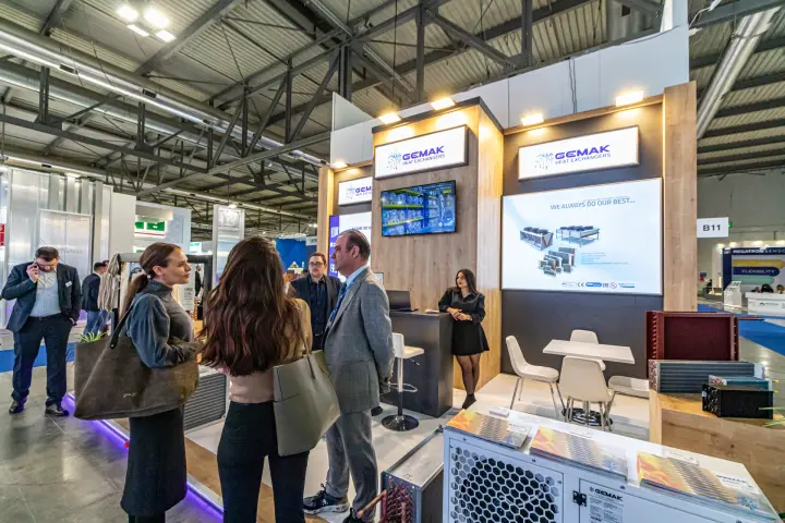 Gemak stand with coil samples and a branded condensing unit by the aisle at MCE 2024