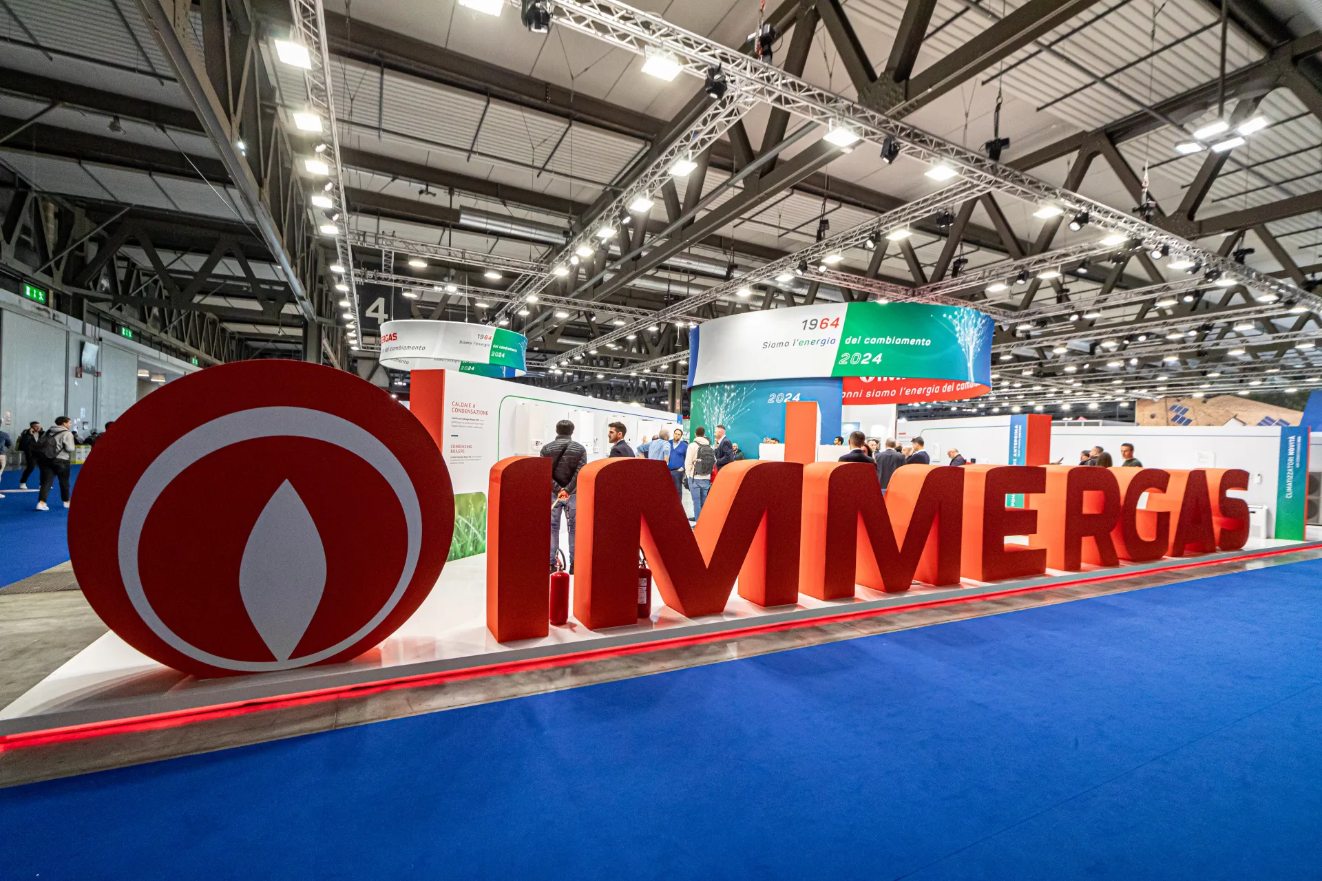 Giant red Immergas letters and flame logo at the front of the stand at MCE 2024