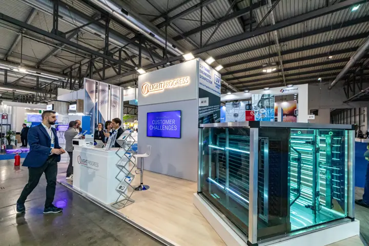 Glowing UV-C lamp arrays in a glass-walled section at Light Progress at MCE 2024