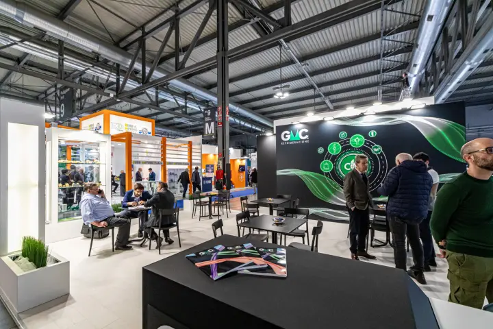 GMC Refrigerazione stand with black graphic wall and meeting tables at MCE 2024