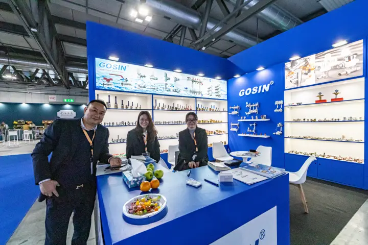 Gosin stand in royal blue with backlit shelves of valves and manifolds