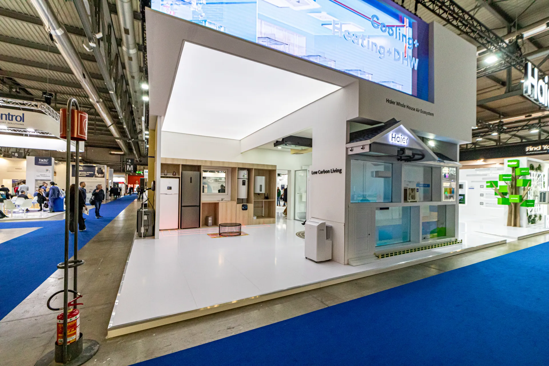 Haier Whole House Air Ecosystem display with kitchen set and LED screen at MCE 2024