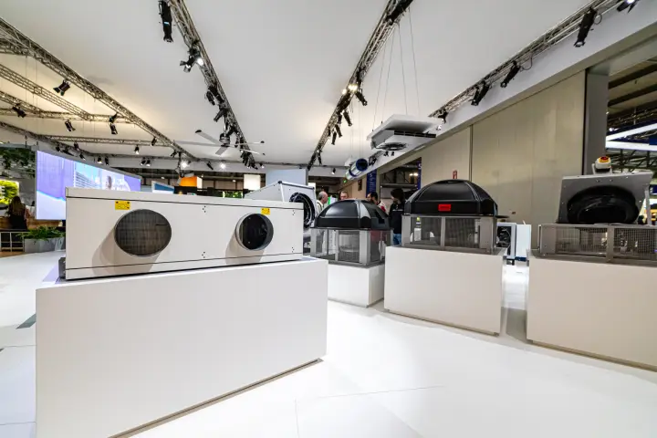 Heat recovery unit and black-domed roof fans on white plinths