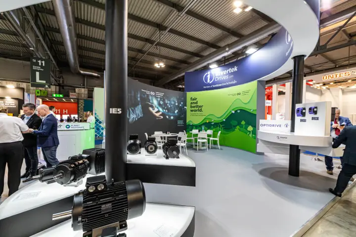 IE5 electric motors in front of Invertek Drives' green 'fair and better world' wall at MCE 2024