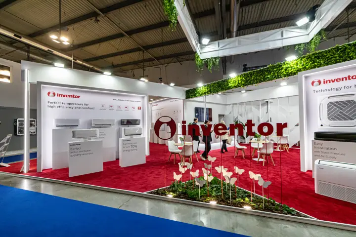 Inventor stand with wall-mounted air conditioners and red carpet at MCE 2024
