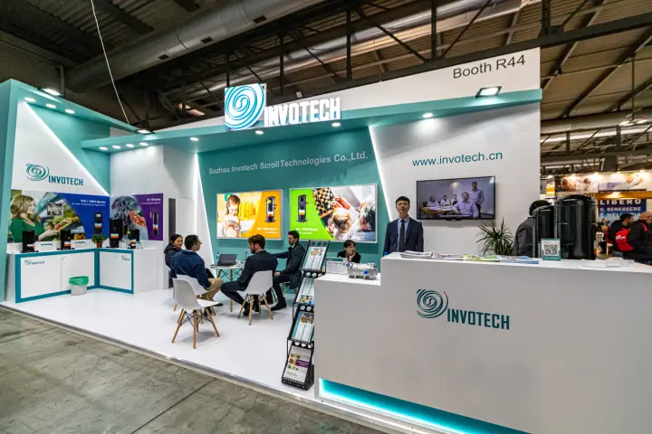 Invotech scroll compressor stand with illuminated logo and Booth R44 sign at MCE 2024