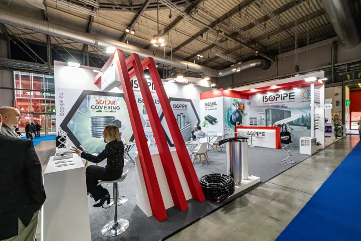 Isopipe stand with red portal frames and pre-insulated pipe displays at MCE 2024