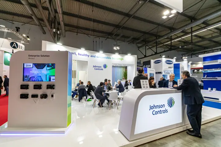 Johnson Controls stand with Metasys display and a full meeting area at MCE 2024