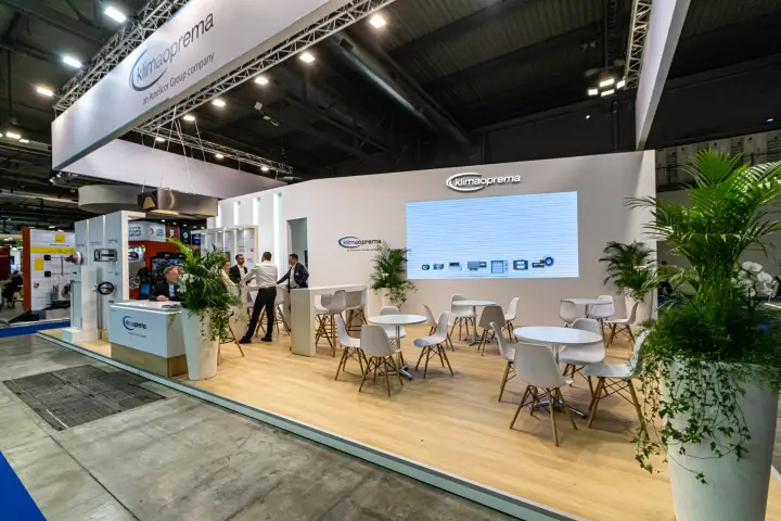 Klimaoprema stand with lounge seating and LED wall of product icons