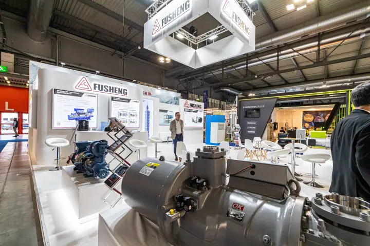 Large grey Fusheng compressor in front of screw compressor panels at MCE 2024