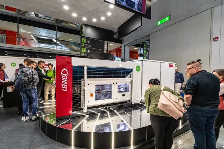 Lennox R32 outdoor unit with open electrical panels on a lit platform at MCE 2024