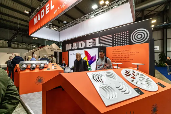 Madel diffusers on orange house-shaped plinths under 'we shape the air' at MCE 2024