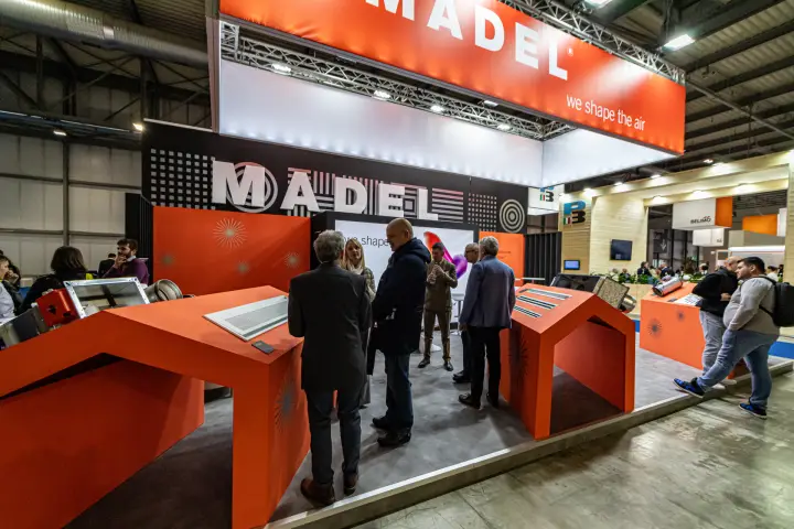 Madel stand with orange house-shaped plinths showing grilles at MCE 2024