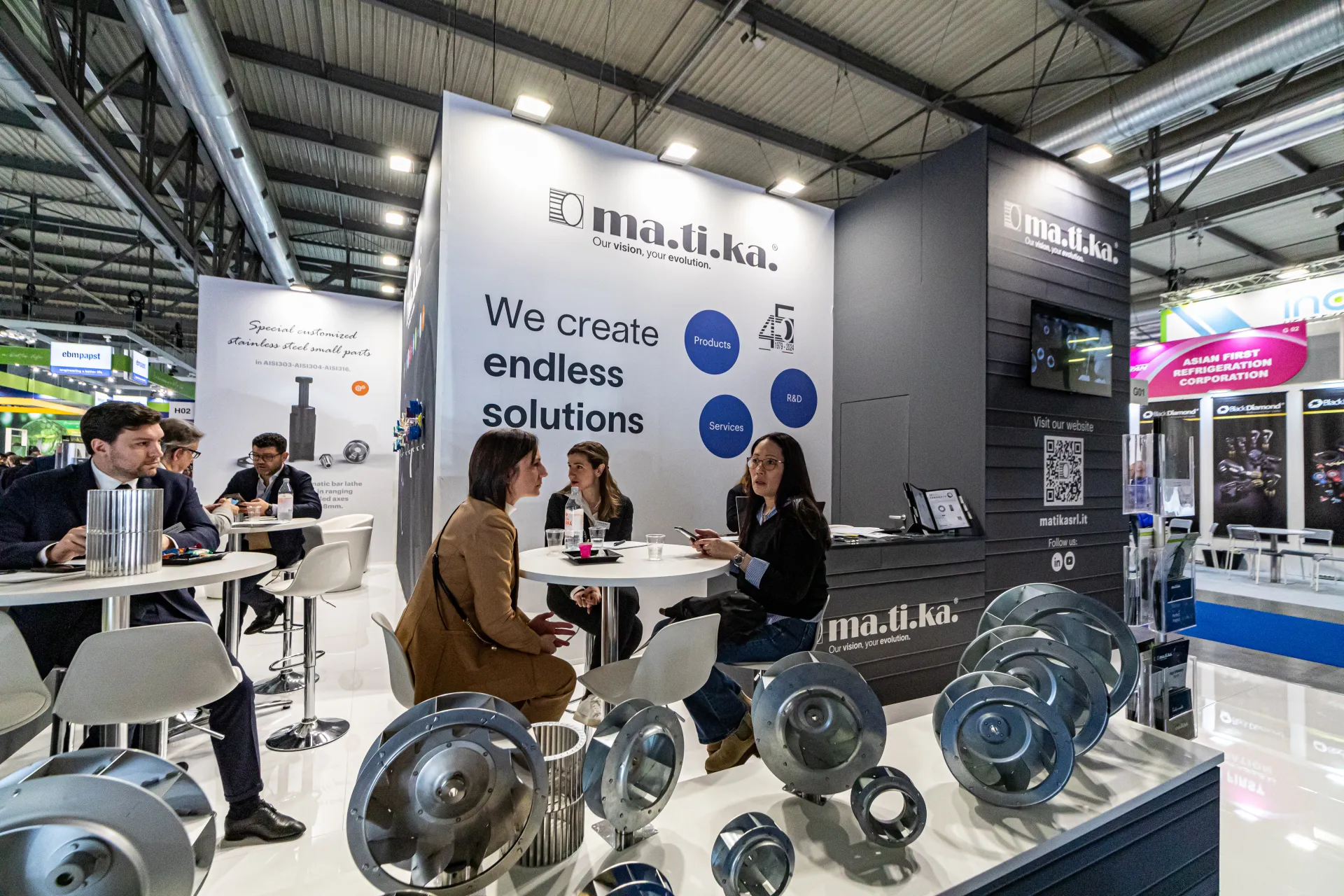 Matika stand with centrifugal fan impellers in front of meeting tables at MCE 2024