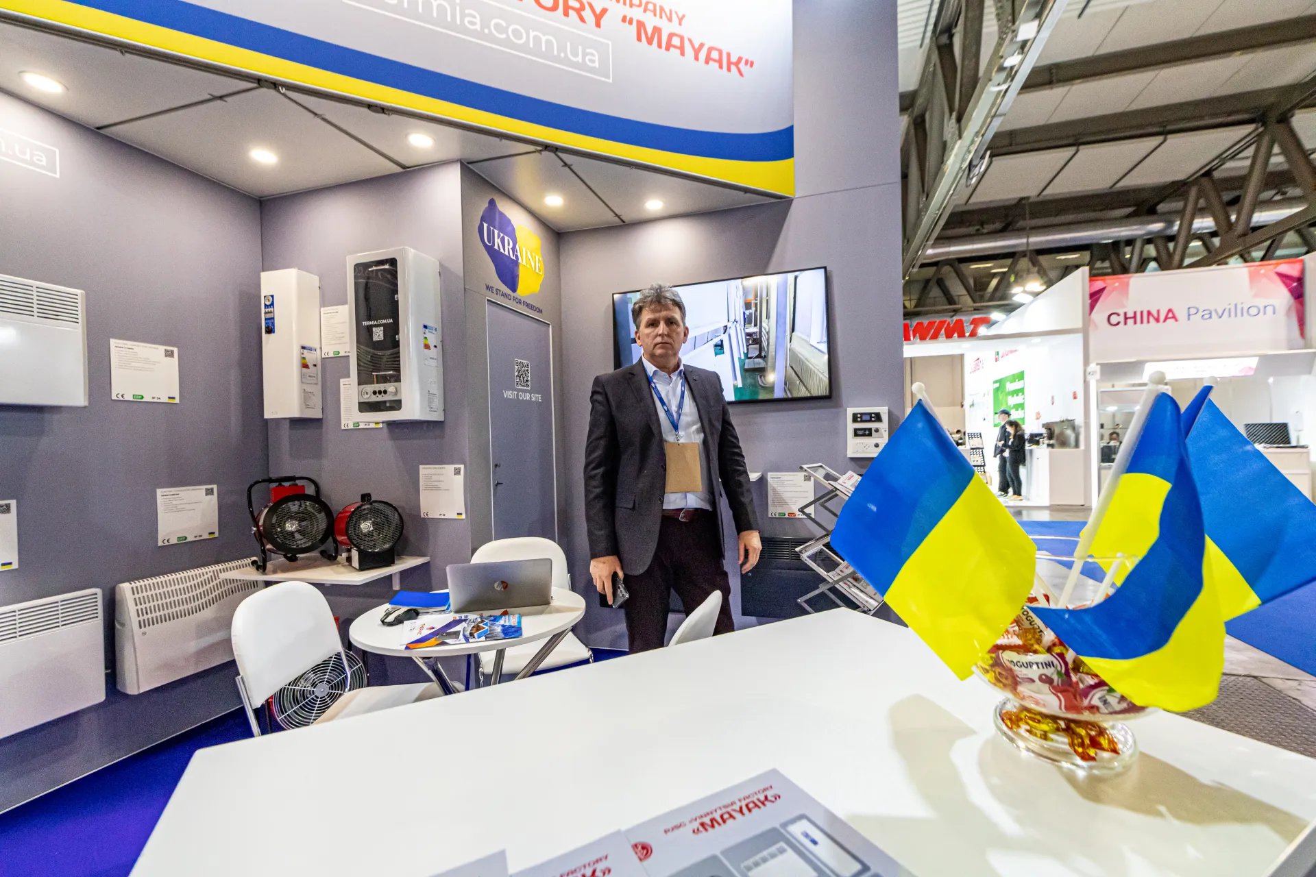 Mayak stand counter with Ukrainian flags, fan heaters and wall convectors at MCE 2024