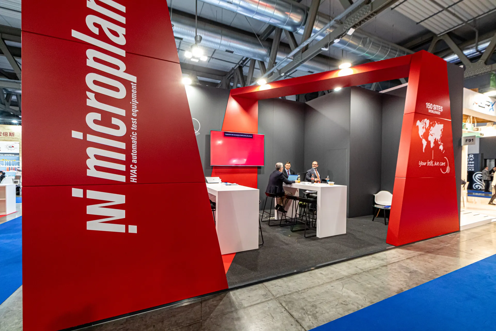 Microplan stand with red portal frame and 'HVAC automatic test equipment' sign at MCE 2024