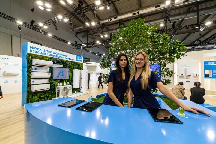 Midea reception counter with tablets and R290 air conditioner green wall at MCE 2024