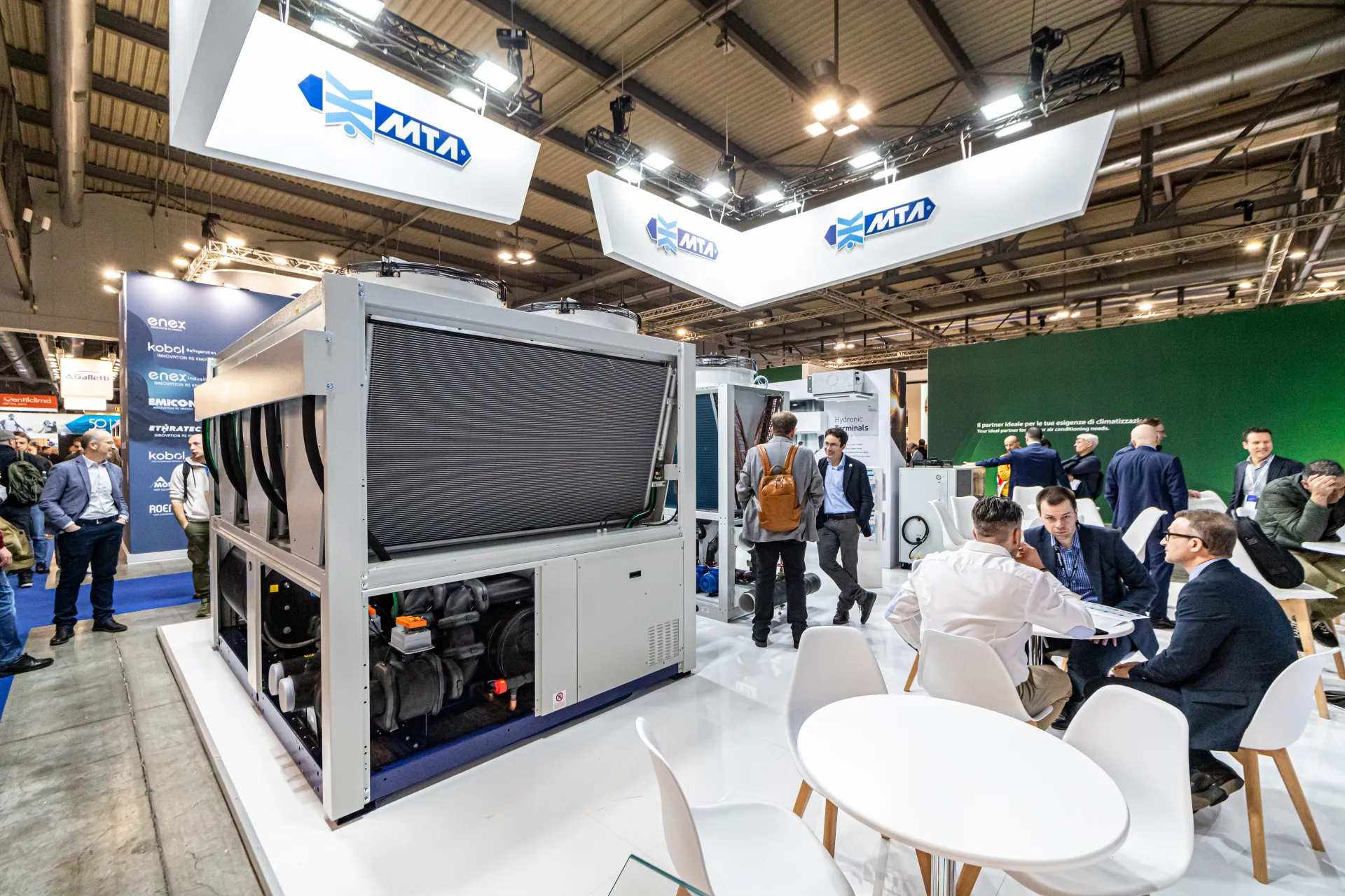 MTA stand with large air-cooled chiller under hanging logo signs at MCE 2024