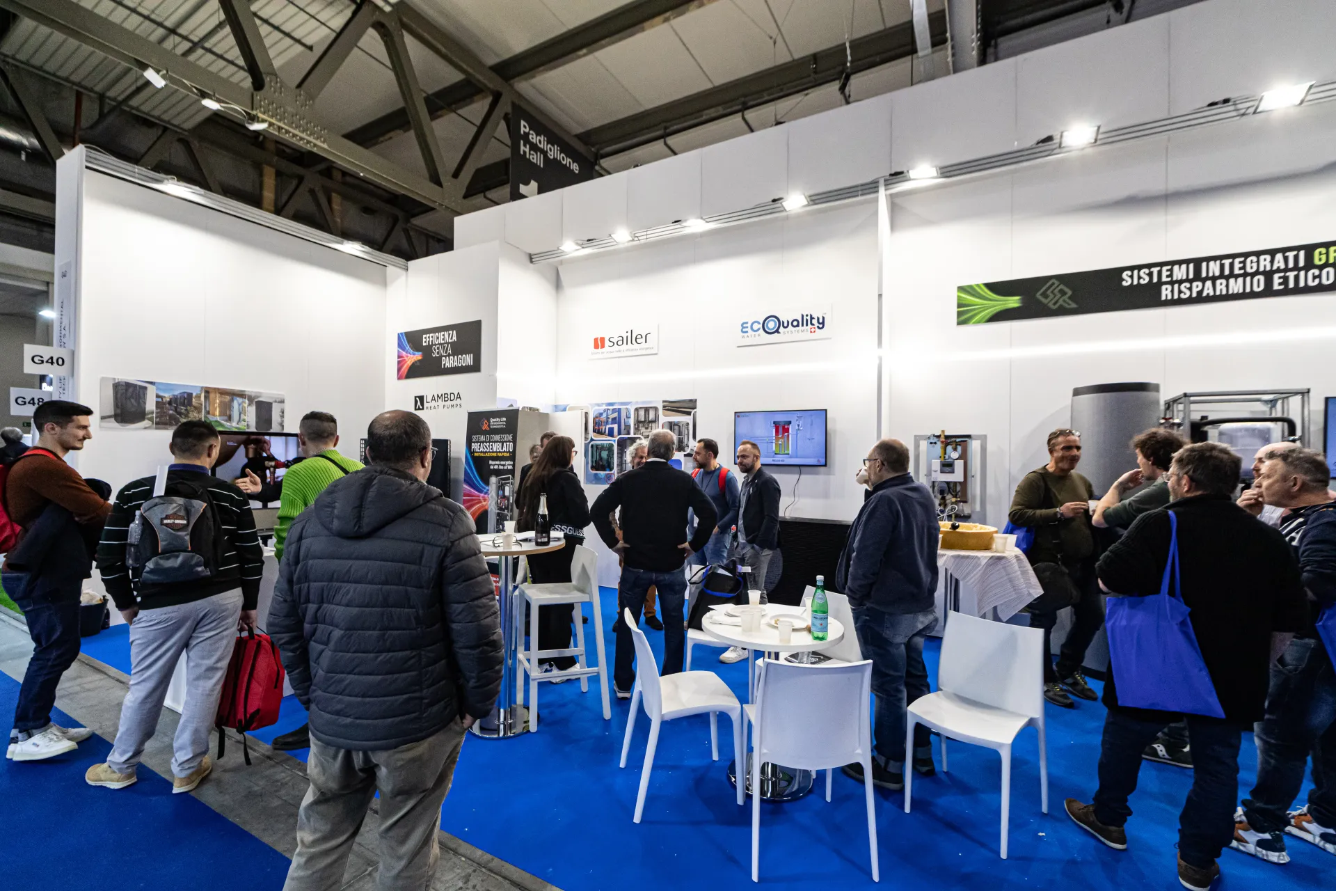 Multi-brand stand with Lambda, Sailer and EcoQuality logos and crowded tables at MCE 2024
