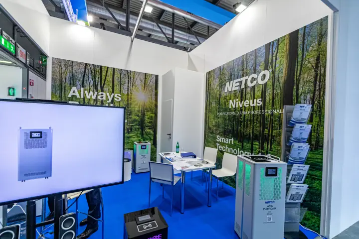 Netco stand with Niveus professional air purifiers and forest-print walls