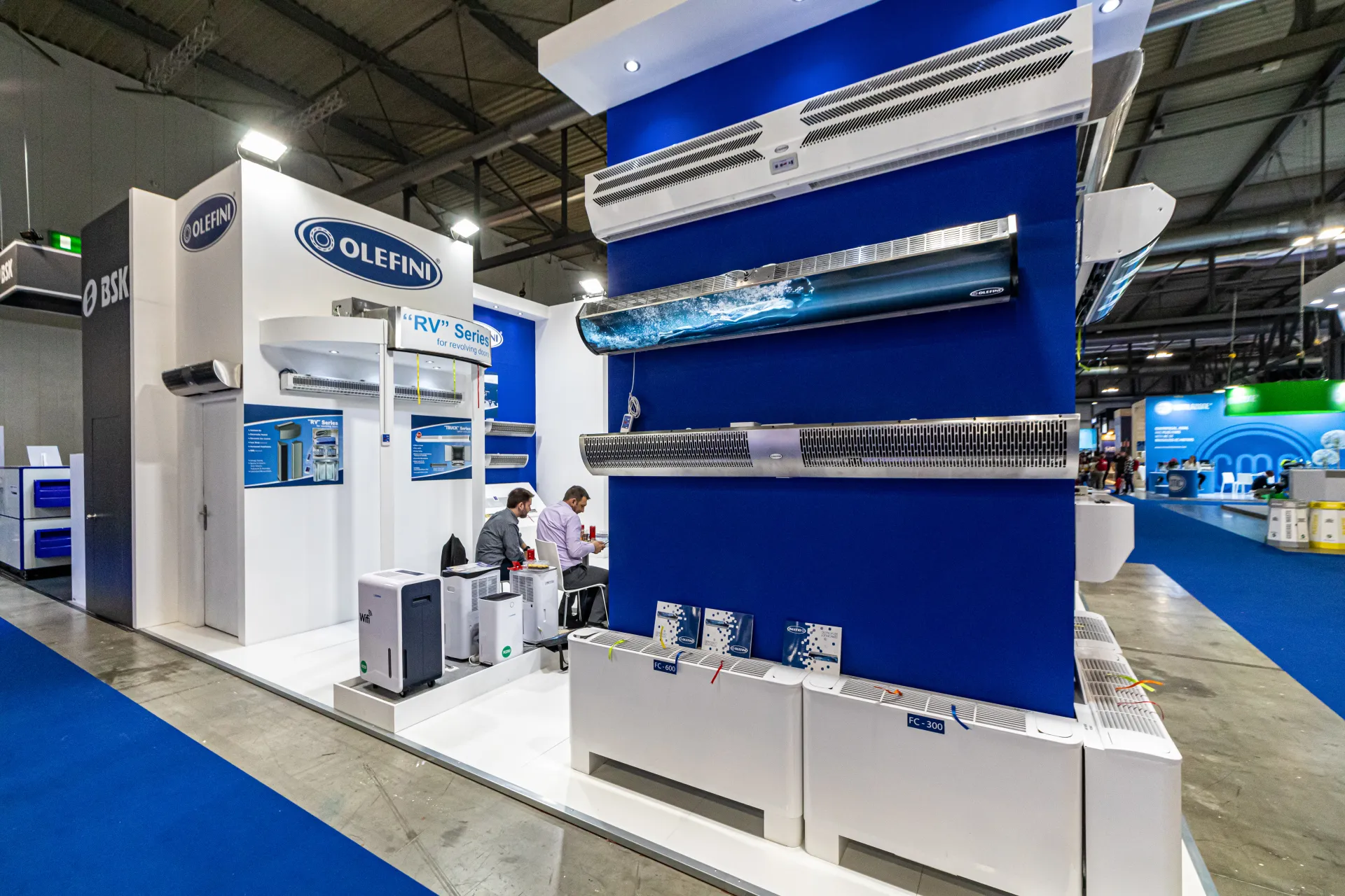 Olefini air curtains and fan coils on a blue display wall at MCE 2024