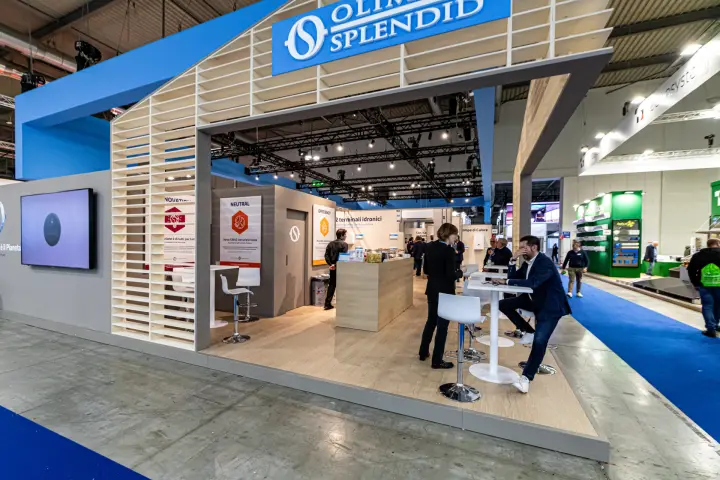 Olimpia Splendid stand entrance with slatted house-shaped frame and bar counter at MCE 2024
