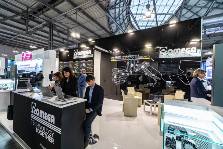 Omega lounge with Technology Together counter and fans in glass case at MCE 2024