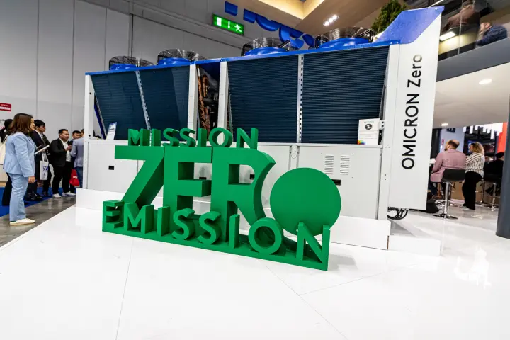 OMICRON Zero unit behind green Mission Zero Emission lettering at MCE 2024