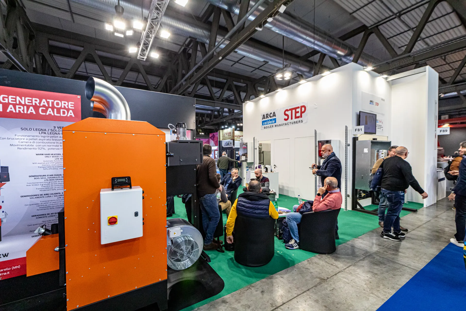 Orange warm air generator in front of the Arca and STEP boiler stand at MCE 2024