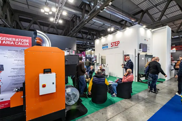 Orange warm air generator in front of the Arca and STEP boiler stand at MCE 2024