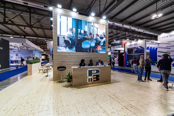 P3 stand with light timber walls, floor and a large video screen at MCE 2024