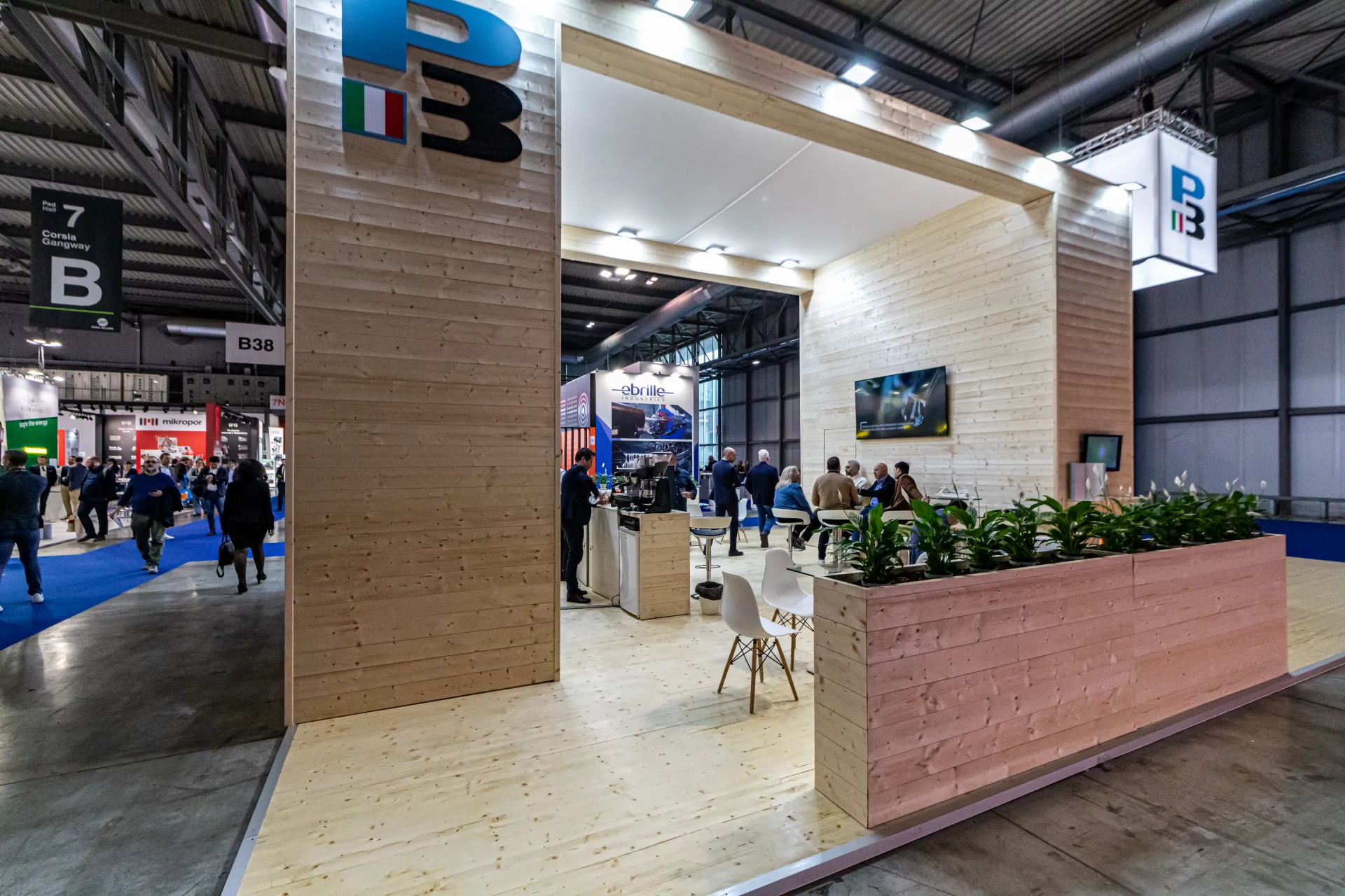 PB stand with timber-clad walls, coffee bar and planted seating area at MCE 2024