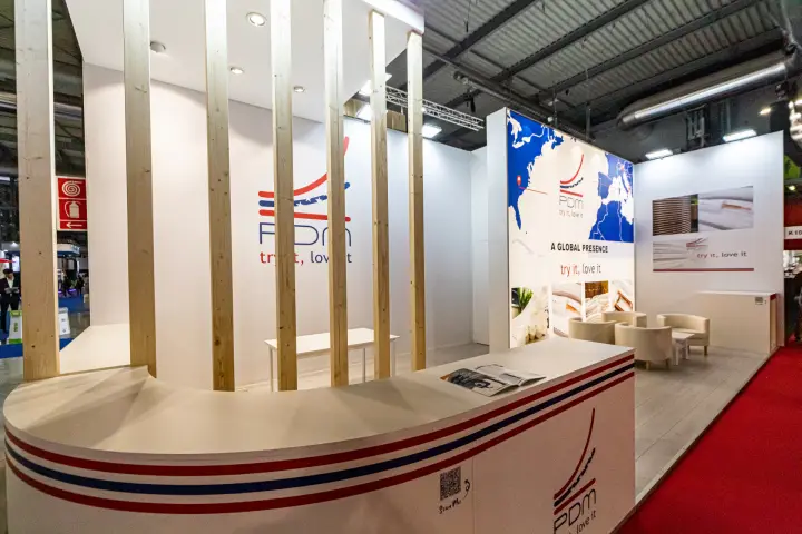 PDM stand with timber posts and "try it, love it" branding at MCE 2024