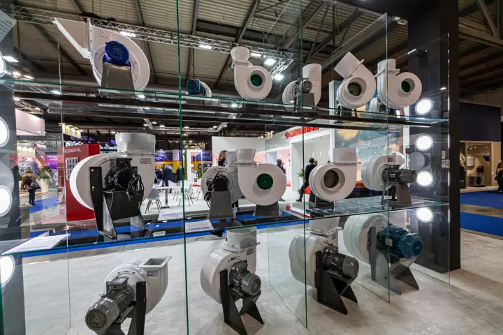 Plastic centrifugal fans with motors on three levels of glass shelving at MCE 2024