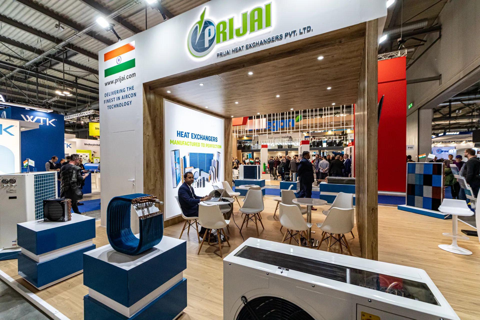 Prijai Heat Exchangers stand with coils and condensing unit under a wooden portal at MCE 2024