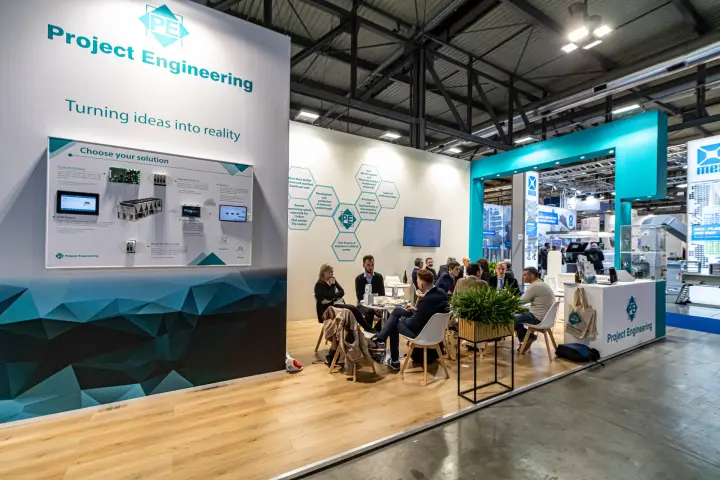 Project Engineering stand with control board solutions and busy meeting area at MCE 2024