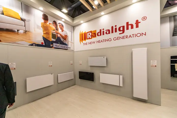 Radialight panel heaters on grey walls under the brand fascia
