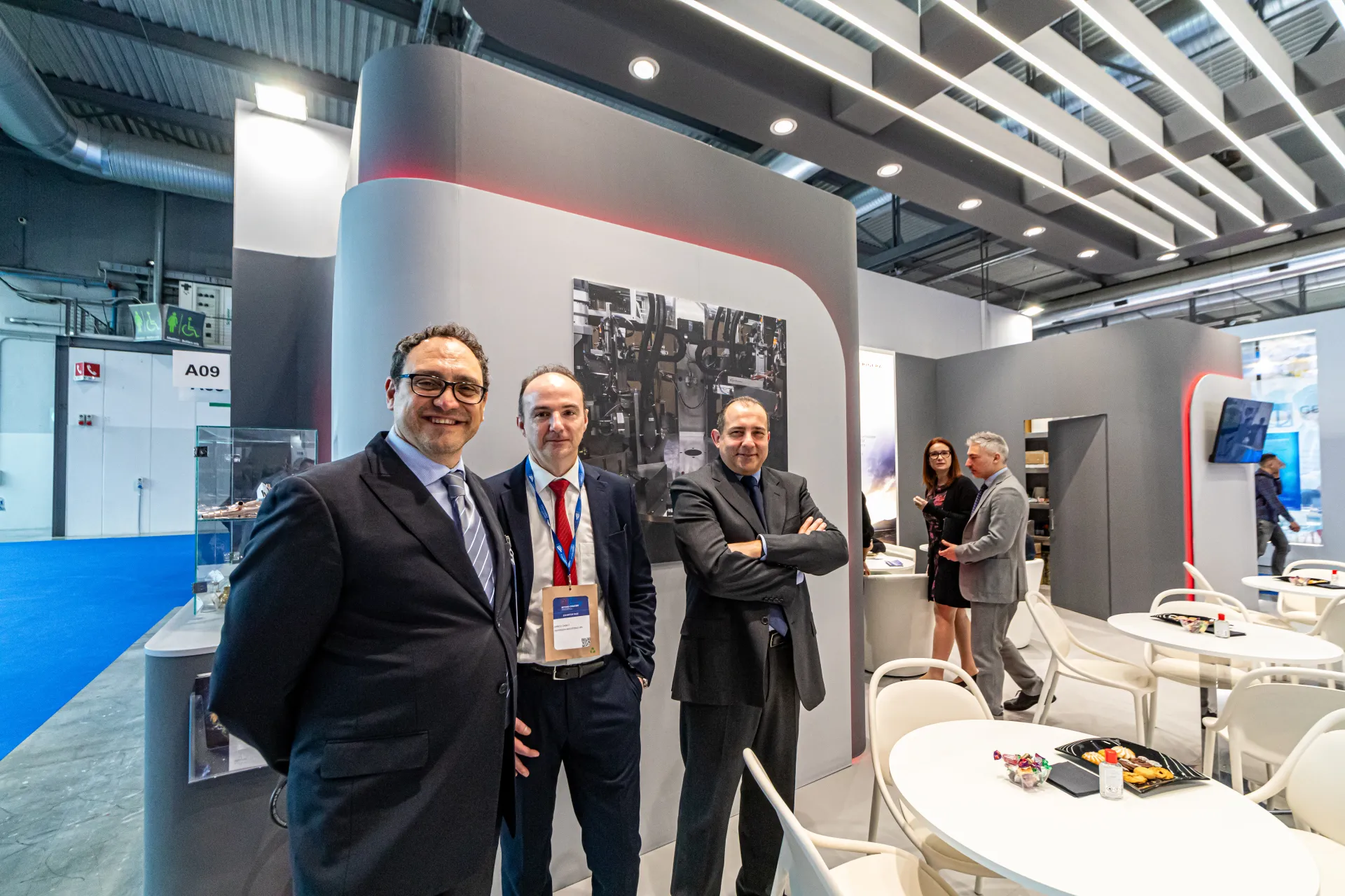 Refrigera staff beside a production photo wall at MCE 2024