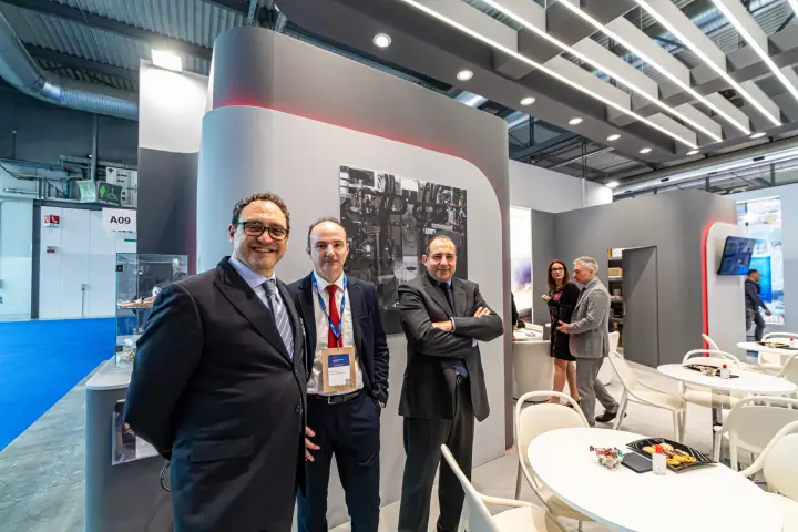 Refrigera staff beside a production photo wall at MCE 2024