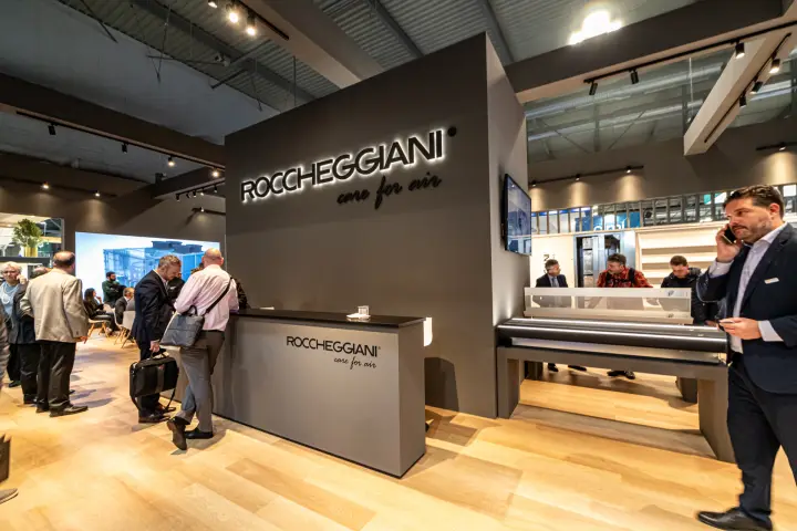 Roccheggiani reception counter beneath the backlit care for air logo at MCE 2024