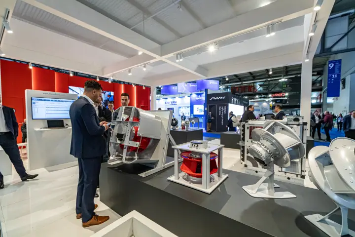 Rosenberg fans on a dark plinth with ECFanGrid module and red wall at MCE 2024