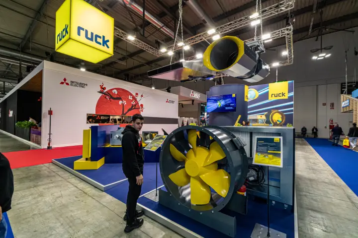 Ruck illuminated cube logo above a large axial fan and suspended jet fan